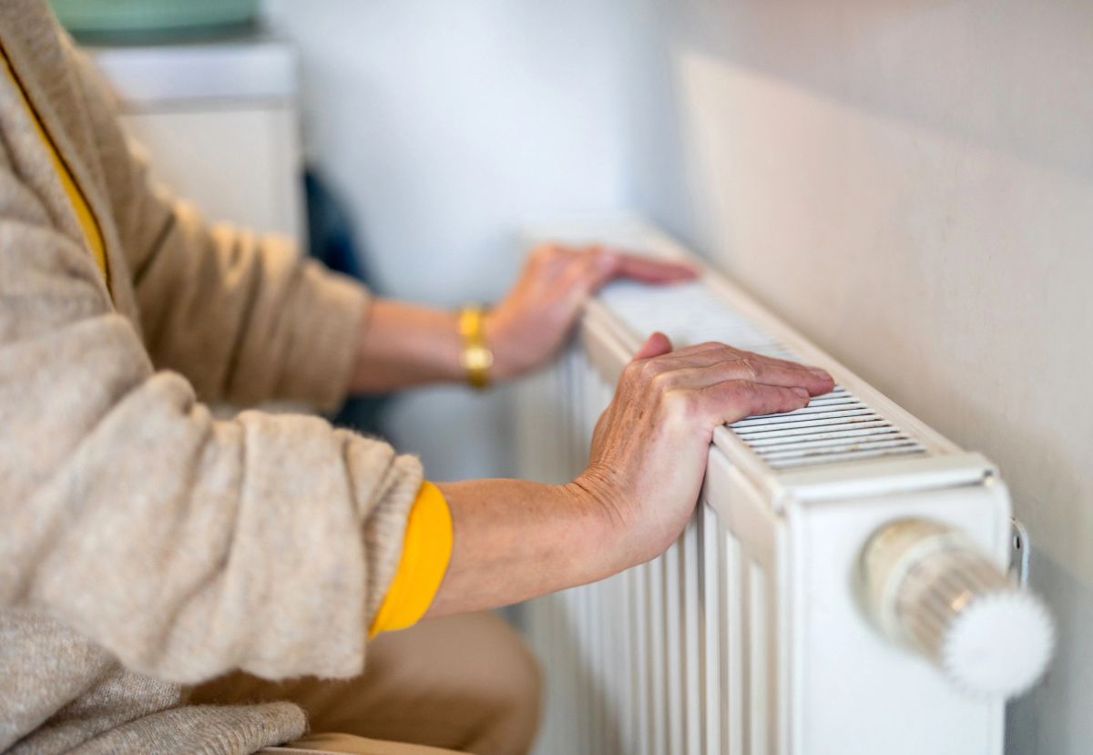 Hands resting on a warm radiator